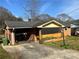 Brick house with a gated entrance and attached carport on a sunny day at 2019 Thomasville Se Dr, Atlanta, GA 30315