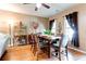 View of the dining room, featuring hardwood floors, large windows, decorative curtains, and overhead fan at 2904 Ridgeview Sw Dr, Atlanta, GA 30331