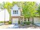 A charming two-story home boasts a blend of siding and stone, complemented by a two-car garage and lush landscaping at 2904 Ridgeview Sw Dr, Atlanta, GA 30331