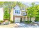 Charming two-story home with a mix of siding and stone, two-car garage and manicured landscaping at 2904 Ridgeview Sw Dr, Atlanta, GA 30331