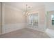 Elegant dining room featuring wainscoting, chandelier, and large window at 3915 Deerborne Dr, Cumming, GA 30040