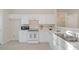 Well-lit kitchen with all-white appliances and cabinets, maximizing space and brightness at 3915 Deerborne Dr, Cumming, GA 30040