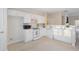 Bright kitchen with white appliances, cabinets, breakfast bar and open view to living room at 3915 Deerborne Dr, Cumming, GA 30040