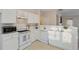 Well-lit kitchen equipped with modern appliances, white cabinetry, and a convenient breakfast bar at 3915 Deerborne Dr, Cumming, GA 30040
