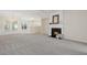 Spacious living room with fireplace, plush carpeting, and abundant natural light at 3915 Deerborne Dr, Cumming, GA 30040