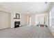 Cozy living room with a fireplace, ample natural light, and neutral carpet at 3915 Deerborne Dr, Cumming, GA 30040