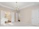 Main bedroom boasts ample natural light, an elegant chandelier, and entry to main bath at 3915 Deerborne Dr, Cumming, GA 30040