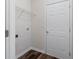 Mudroom includes door to garage, hardwood floors, shelving unit, and white trim at 3915 Deerborne Dr, Cumming, GA 30040