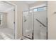 Bright bathroom featuring tile shower, built-in seat, and grab bar for accessibility at 3915 Deerborne Dr, Cumming, GA 30040