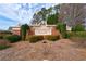 Manchester Court neighborhood sign with brick base and manicured landscaping at 3915 Deerborne Dr, Cumming, GA 30040