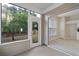 Sunroom features large windows overlooking lush greenery and a seamless access to the kitchen at 3915 Deerborne Dr, Cumming, GA 30040