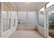 Enclosed sunroom with lots of natural light, neutral palette, and views of backyard at 3915 Deerborne Dr, Cumming, GA 30040
