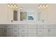Bathroom with double vanity and white cabinets at 5620 Weddington Drive Dr, Cumming, GA 30040