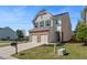 Beautiful two-story home with a brick and siding exterior, two-car garage, and manicured front yard at 5620 Weddington Drive Dr, Cumming, GA 30040