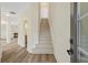 Inviting foyer with hardwood floors, staircase, and open view into the living room with a fireplace at 5620 Weddington Drive Dr, Cumming, GA 30040