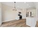 Bright kitchen with white cabinets and stainless steel appliances at 5620 Weddington Drive Dr, Cumming, GA 30040