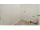Laundry room with tiled floor, hookups, and a wire rack shelf at 5620 Weddington Drive Dr, Cumming, GA 30040