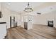 Open-concept living room with fireplace and modern lighting at 5620 Weddington Drive Dr, Cumming, GA 30040