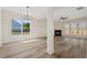 Bright living room featuring hardwood floors, large windows, a fireplace, and elegant trim work at 5620 Weddington Drive Dr, Cumming, GA 30040