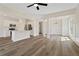 Open concept living space featuring hardwood floors, a fireplace, kitchen, and dining area with modern finishes at 5620 Weddington Drive Dr, Cumming, GA 30040