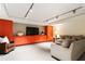 Cozy finished basement with seating, an entertainment center, and bright orange storage at 123 Peachtree Cir, Atlanta, GA 30309
