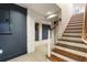Finished basement with brick columns, neutral carpet and stairs to the main level at 123 Peachtree Cir, Atlanta, GA 30309