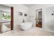 Bright bathroom with a soaking tub and marble floors at 123 Peachtree Cir, Atlanta, GA 30309