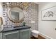 Charming powder room with patterned wallpaper, a stylish vanity, and a round mirror at 123 Peachtree Cir, Atlanta, GA 30309