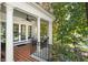 Relaxing covered porch with brick flooring, white columns, and comfortable seating at 123 Peachtree Cir, Atlanta, GA 30309