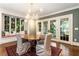 Bright dining room featuring an elegant chandelier, window seat, and ample light through the french doors and windows at 123 Peachtree Cir, Atlanta, GA 30309