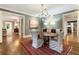 Charming dining room with hardwood floors, a modern light fixture, and seamless transition to adjacent rooms for entertaining at 123 Peachtree Cir, Atlanta, GA 30309