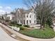 An inviting exterior elevation with mature trees, brick accents, and a well-manicured lawn at 123 Peachtree Cir, Atlanta, GA 30309