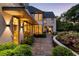 The house's exterior with manicured landscaping, stone patio, and abundant natural light at 123 Peachtree Cir, Atlanta, GA 30309