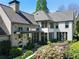 Lovely exterior with lush landscaping, stone walkway, and large windows for natural light at 123 Peachtree Cir, Atlanta, GA 30309