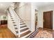 Beautiful foyer with hardwood floors, paneled walls, and staircase with wood treads at 123 Peachtree Cir, Atlanta, GA 30309