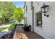 Charming front porch with brick flooring, seating, and views of the landscaped yard at 123 Peachtree Cir, Atlanta, GA 30309