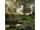 Picturesque greenspace with a tranquil pond, trees, and buildings in the background at 123 Peachtree Cir, Atlanta, GA 30309