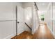 Hallway featuring wood floors, paneled walls, and access to stairs with a ladder at 123 Peachtree Cir, Atlanta, GA 30309