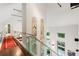 Bright upstairs hallway with glass railing, modern lighting, and artwork, overlooking the courtyard at 123 Peachtree Cir, Atlanta, GA 30309