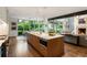 Open concept kitchen features a large island, dining area, and view to the backyard with mature landscaping at 123 Peachtree Cir, Atlanta, GA 30309