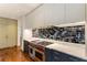 Well-equipped kitchen with stainless steel oven range and modern backsplash, plus gray and blue cabinetry at 123 Peachtree Cir, Atlanta, GA 30309