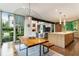 Open concept kitchen and dining area with contemporary lighting, view to great room, and backyard access at 123 Peachtree Cir, Atlanta, GA 30309