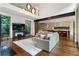 Open-concept living room with hardwood floors, a comfortable couch, and views of a landscaped yard at 123 Peachtree Cir, Atlanta, GA 30309