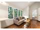 Cozy living room featuring a wall of windows, hardwood floors, and an adjacent door at 123 Peachtree Cir, Atlanta, GA 30309