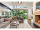 Bright living room featuring a fireplace, hardwood floors, large windows, and comfortable seating at 123 Peachtree Cir, Atlanta, GA 30309