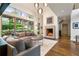 Bright living room featuring hardwood floors, large windows, a fireplace, and stylish furniture at 123 Peachtree Cir, Atlanta, GA 30309