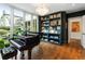 Living room features a piano, a custom bookcase and large windows with a view to the backyard at 123 Peachtree Cir, Atlanta, GA 30309
