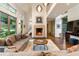 Open-concept living room with hardwood floors, a fireplace, and abundant natural light from large windows at 123 Peachtree Cir, Atlanta, GA 30309