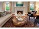 Comfortable living room showcasing a fireplace, stylish decor, hardwood floors, and a decorative rug with soft lighting at 123 Peachtree Cir, Atlanta, GA 30309