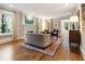 Cozy living room featuring a fireplace, hardwood floors, a beautiful rug, and ample natural light through the windows at 123 Peachtree Cir, Atlanta, GA 30309